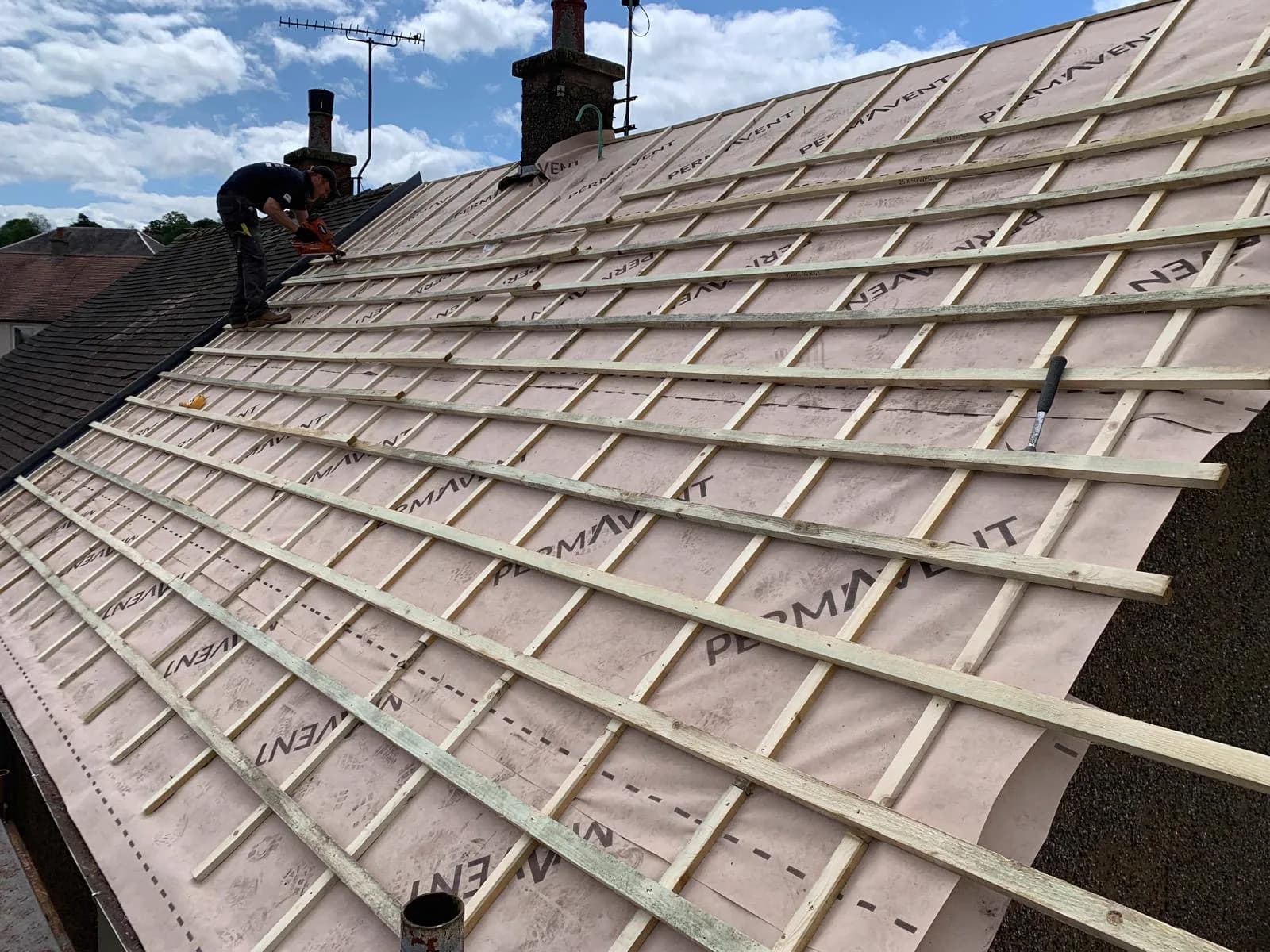 Thistle Roofing tradesman fitting battens and breathable membrane on a new roof
