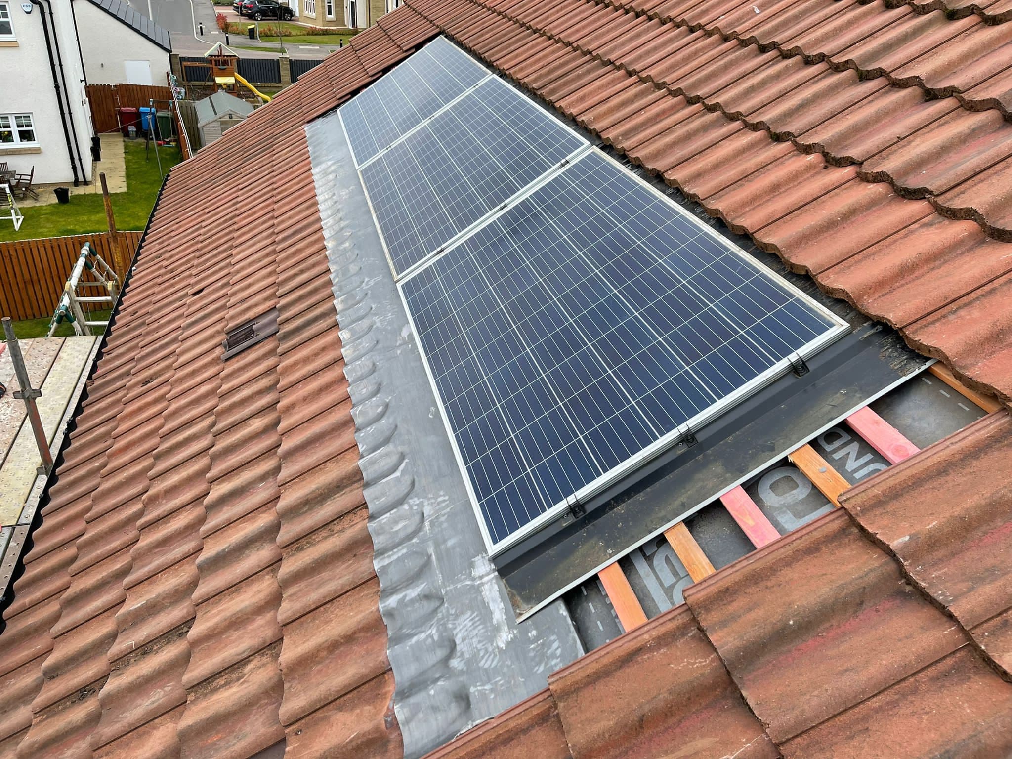 Solar panels re-fitted with new lead flashings on a slate roof