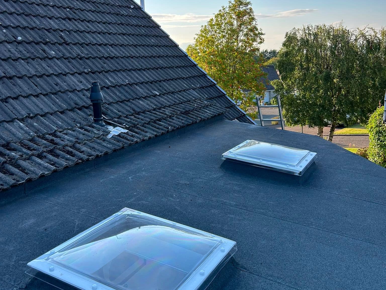 New felt flat roof with dome rooflights fitted over a conservatory extension